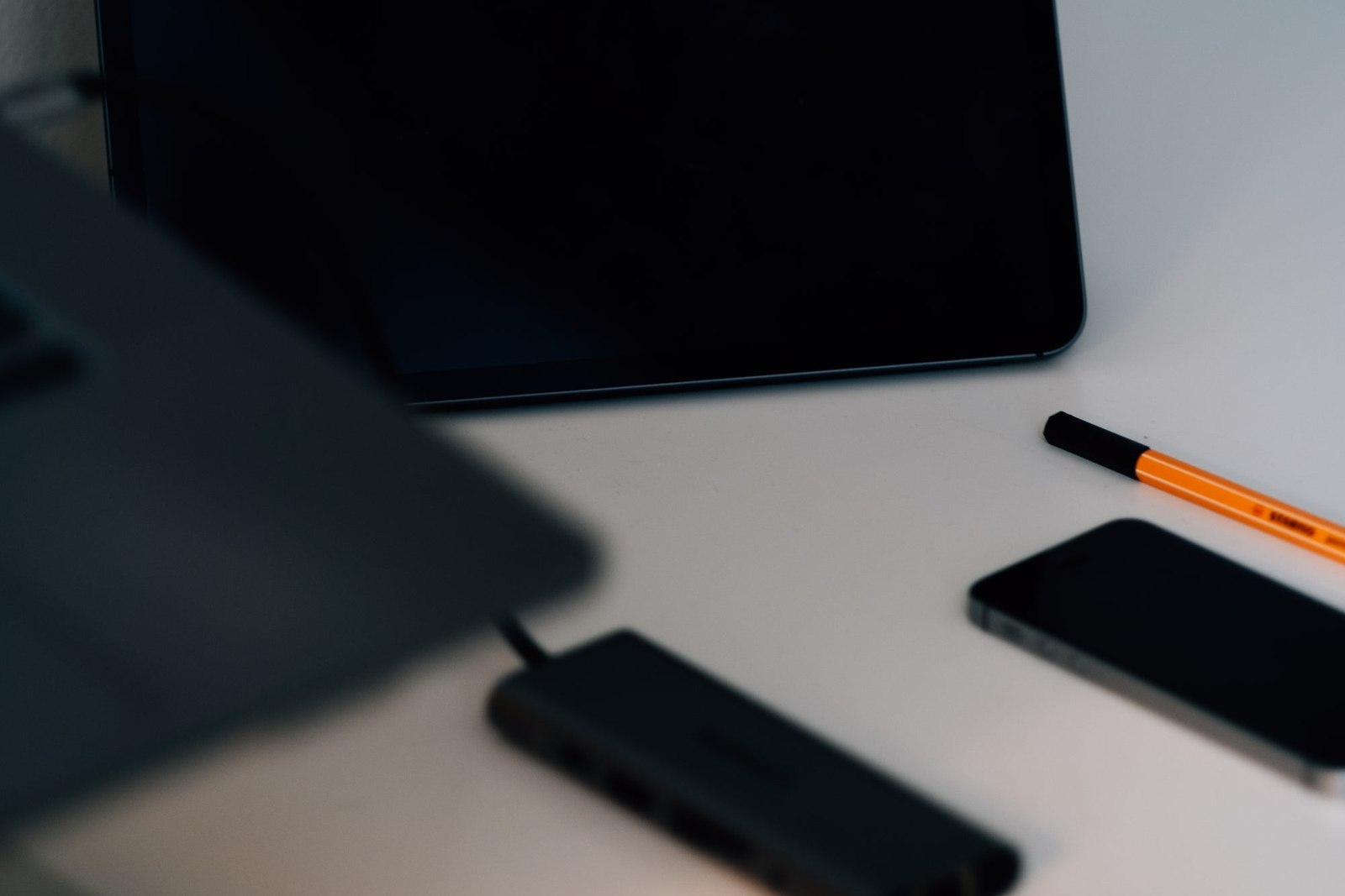 Desk With Some Black Gadgets In Focus